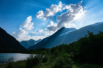 Fototapeta premium Sunbeam through clouds at norwegian mountains