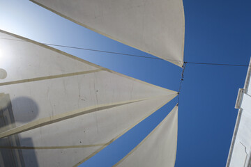 white sun screens against a bright blue sky