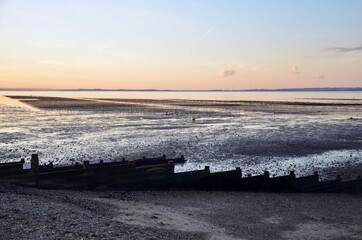 Oyster beds on the coast of the seaside town Whitstable in Kent at sunset, UK, evening sky in autumn