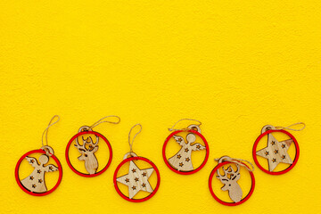 Spruce branch, cones and vintage toys decoration on christmas or new year on yellow background