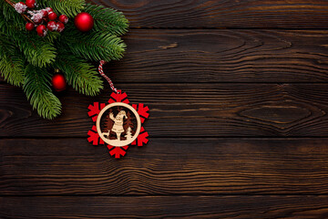 Spruce branch, cones and vintage toys decoration on christmas or new year on dark wooden background.
