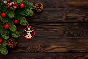 Spruce branch, cones and vintage toys decoration on christmas or new year on dark wooden background.