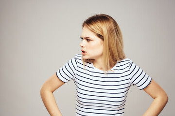 Obraz premium Emotional blonde woman in striped t-shirt lifestyle facial expression close-up