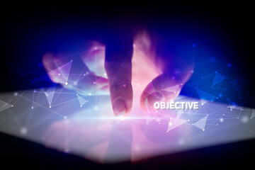 Finger touching tablet with OBJECTIVE inscription, business concept