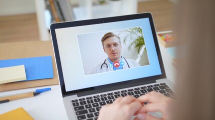 Woman Using Laptop to Talk to His Young Blonde Doctor via Video Conference Medical Person Checks...
