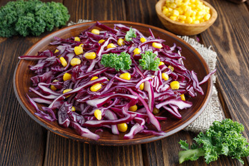 Sliced red cabbage salad with corn. Healthy food.
