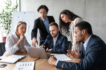 United Business Team Working Together At Laptop In Modern Office