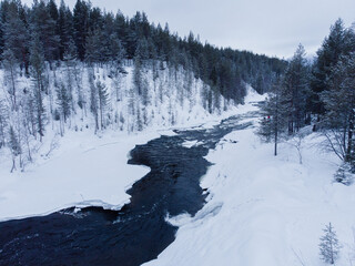 Fototapeta na wymiar Drone view of the snow-covered northern river. Kola Peninsula, Russia