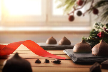 Chocolate truffles on wooden slats with Christmas decoration warmth