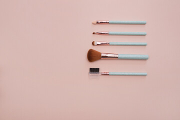 Various makeup brushes on a light pink background with copyspace. Makeup brush set. do makeup. professional makeup artist tools. beauty, fashion, cosmetics