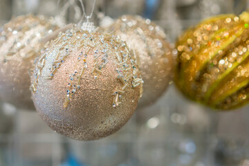 beautiful golden christmas balls on a golden background. Christmas balls close up picture. toned