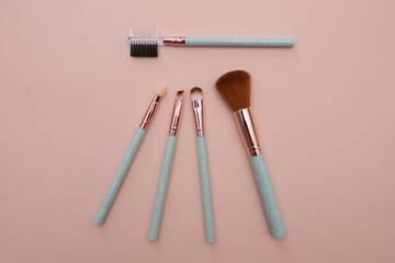 Various makeup brushes on a light pink background with copyspace. Makeup brush set. do makeup. professional makeup artist tools. beauty, fashion, cosmetics