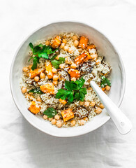 Autumn vegetarian lunch - couscous with pumpkin and eggplant on a light background, top view