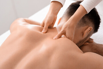 Closeup of man getting acupressure massage at spa salon - obrazy, fototapety, plakaty