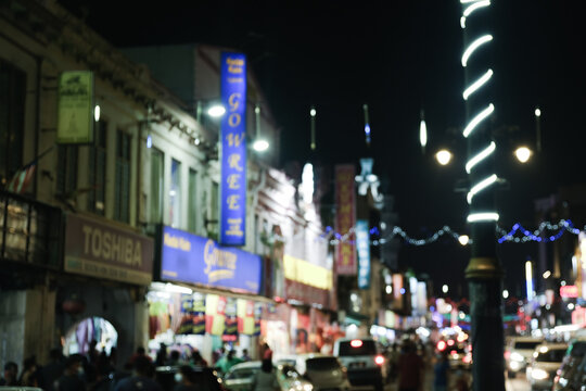 "Klang,Malaysia- Circa November, 2020: Intentional lens blur and light bokeh with noise effect image at busy street in Little India Klang."
