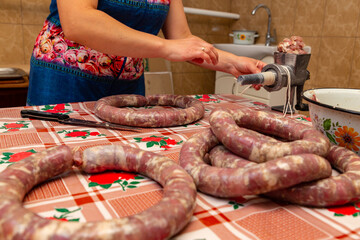 Zinkov. Ukraine. June 17, 2020. A woman makes a traditional homemade sausage.