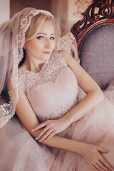 Beautiful bride with nature make-up in pink dress 