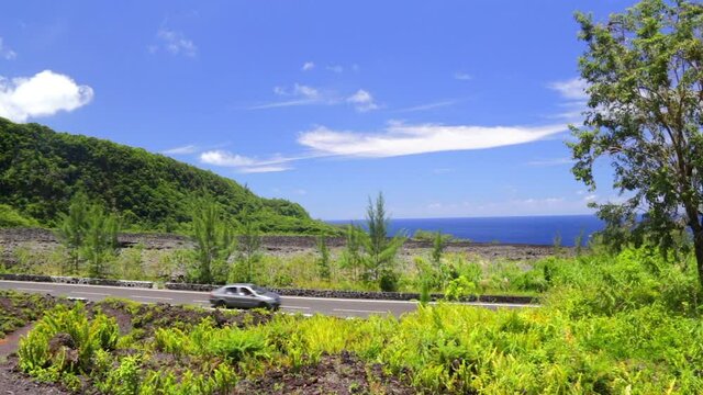 Car driving on the N2 highway and the Lava flows of the Grand Br&ucirc;l&eacute; on Reunion