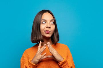 hispanic woman scheming and conspiring, thinking devious tricks and cheats, cunning and betraying