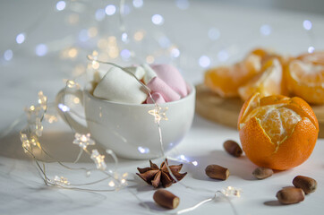 Tangerines, marmalade and garland on a blurred background.