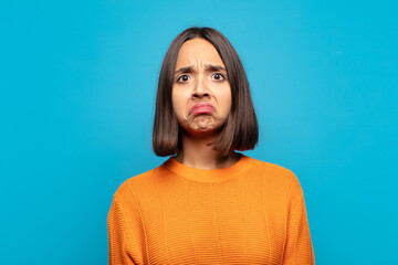hispanic woman feeling sad and stressed, upset because of a bad surprise, with a negative, anxious...