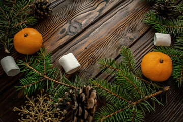 New Year's still life. Flatley. Christmas tree, cones, Christmas toys, tangerines on a wooden background