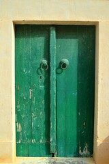 old Traditional wooden green aged Tunisian door with ornament in Kairouan Medina