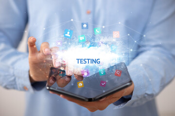 Businessman holding a foldable smartphone with TESTING inscription, technology concept