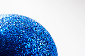 Defocused blue glitter texture surface christmas ball abstract background. Selective soft focus, shallow depth of field.