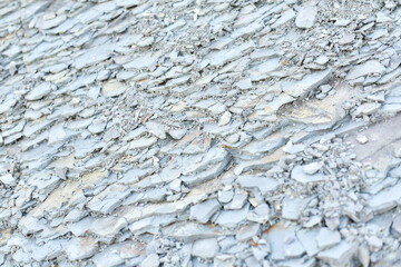 Stone texture background. natural stones on a mountain hill. grey stones damaged by wind and water.