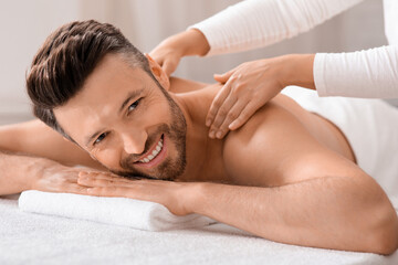 Cheerful middle aged man attending spa salon