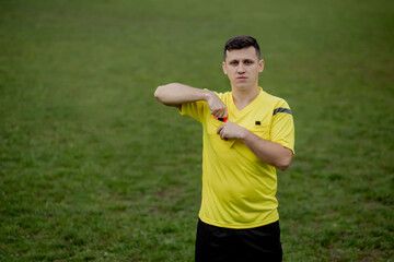 Fototapeta na wymiar Soccer referee to point out a yellow card to a player in the soccer stadium