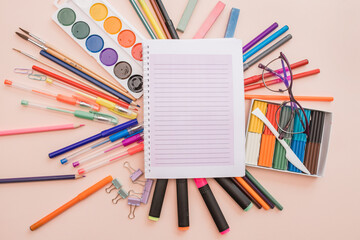 Fototapeta premium School and office supplies. background with colorful school items and stationery collection on pink background. Back to school concept