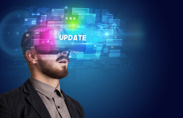 Businessman looking through Virtual Reality glasses with UPDATE inscription, innovative security concept