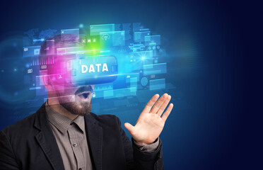 Businessman looking through Virtual Reality glasses with DATA inscription, innovative security concept