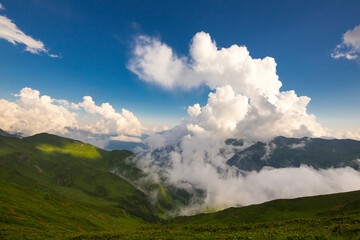 Beautiful mountain landscape at Caucasus mountains with clouds and blue sky