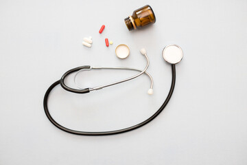 Stethoscope, pills, heart. Isolated over white background. The concept of medicine.