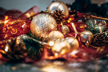 Christmas decoration ornaments reds ribbons, golden balls, light, cones, pine on the background...