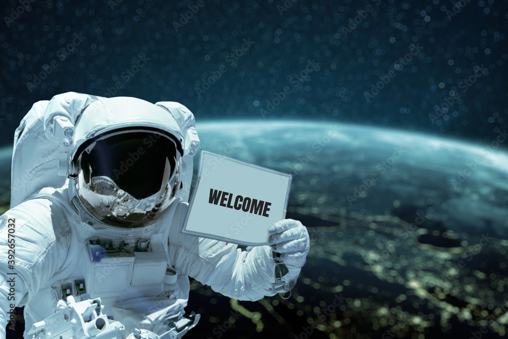 Aufkleber astronaut in a space suit shows a card with the text Welcome spacewalk against the background of the planet Earth. Spaceman in outer space