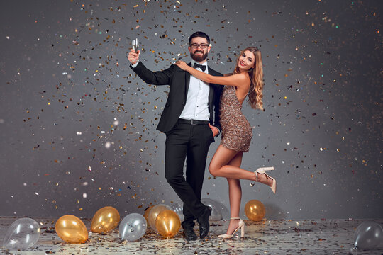 Happy Elegant Couple With Glasses Of Non Alcoholic Champagne At Christmas Or New Year Party.