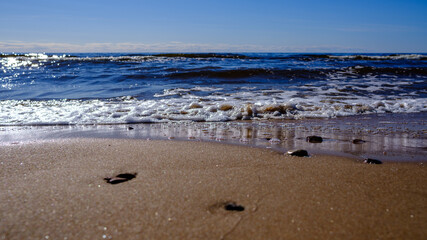 sea shore in summer beach with blue water waves and sand