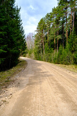 Obraz premium countryside dirt road gravel in perspective in summer