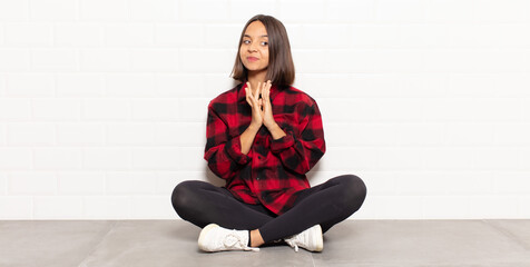hispanic woman feeling proud, mischievous and arrogant while scheming an evil plan or thinking of a...