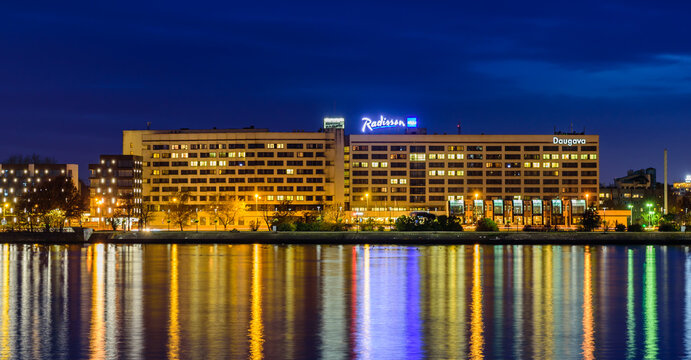 Riga, Latvia - October 18, 2019: beautiful night cityscape of Riga with Daugava river. Radisson hotel at night