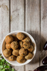Meatless eggplant meatballs on wooden background.