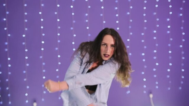 Stylish woman dancing modern dance in a choreographic studio. Slow motion.