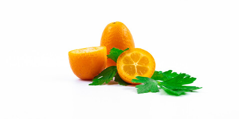 Kumquat or fortunella citrus winter fruit composition in a cut, illustrative photo on white isolated background banner