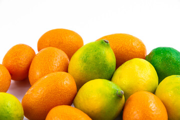 Ripe fresh small citrus kumquat and limequat on white isolated background