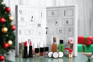 Christmas advent calendar with perfume and makeup products on table