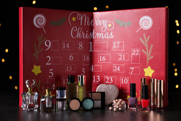 Christmas advent calendar with perfumes and makeup products on table